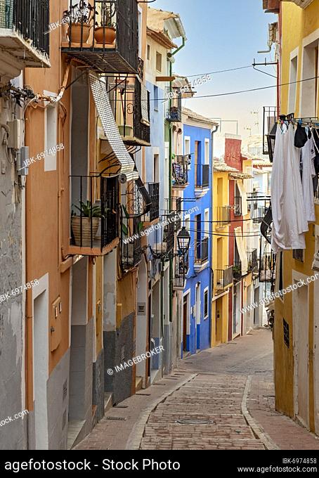 Narrow street with colorful houses in seaside town of Villajoyosa, Spain, Europe
