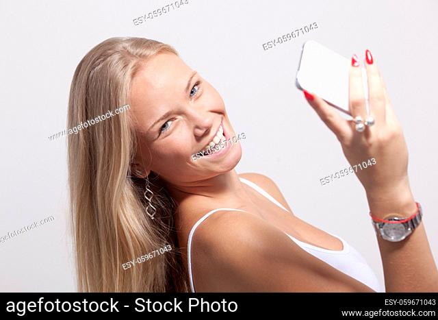 Young Woman hold cell phone smartphone and smiling