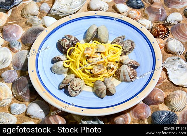 Italian food for Mediterranean healthy diet, risotto with pumpkin, spaghetti with clams