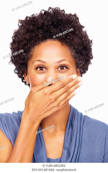 Closeup of smiling young woman covering her mouth with hand on white background
