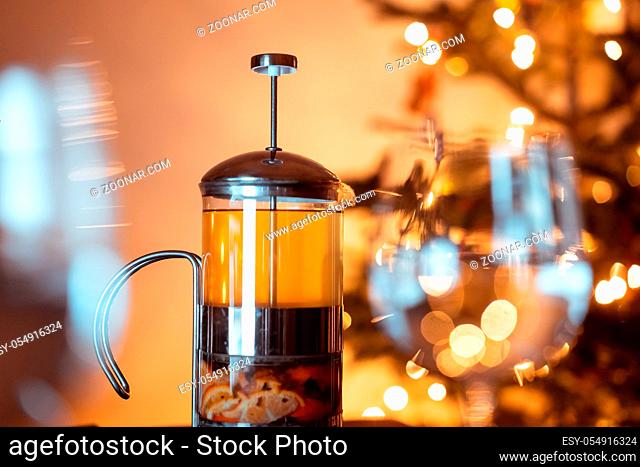Teapot french press with green tea and tangerine slices on christmas background