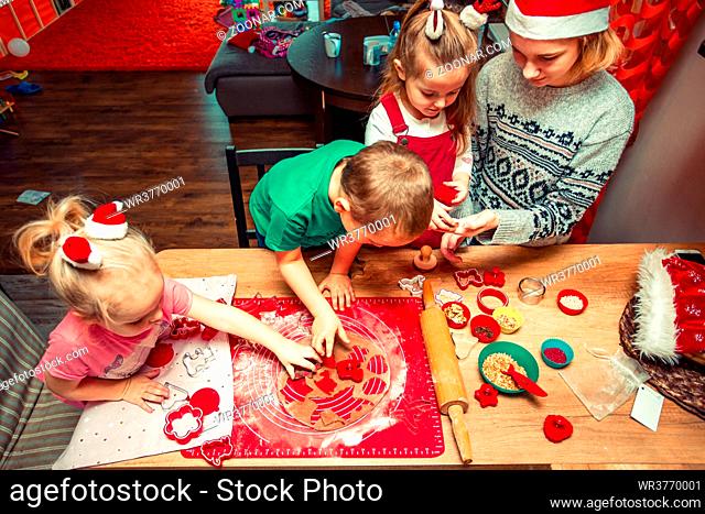 Baking Christmas cookies. Christmas gingerbread cookies in many shapes decorated with colorful frosting, sprinkle, icing, chocolate coating, toppers