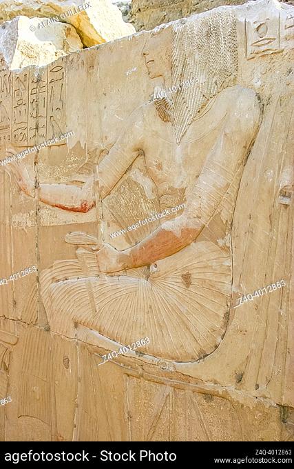 Egypt, Saqqara, tomb of Horemheb, statue room, Horemheb in fine relief is seated