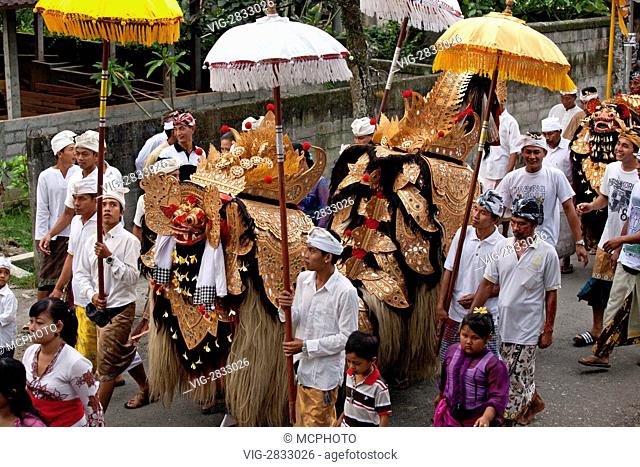 A BARONG COSTUME used in traditional LEGONG dancing is carried during a HINDU PROCESSION for a temple anniversary - UBUD, BALI - 03/12/2010