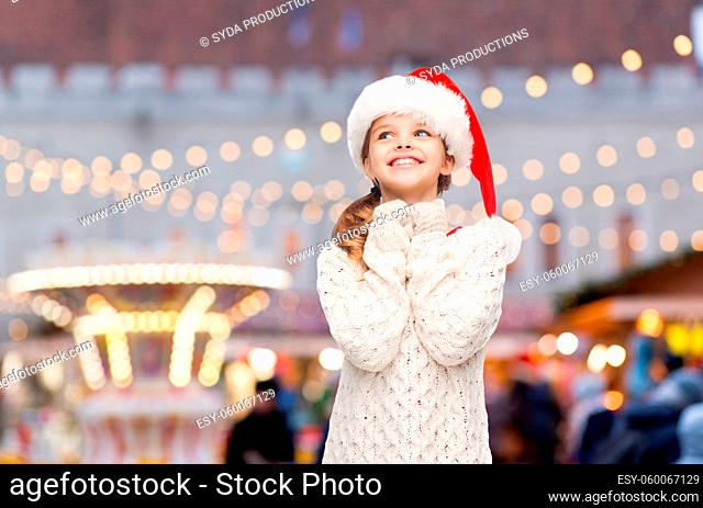 happy smiling girl dreaming over christmas market