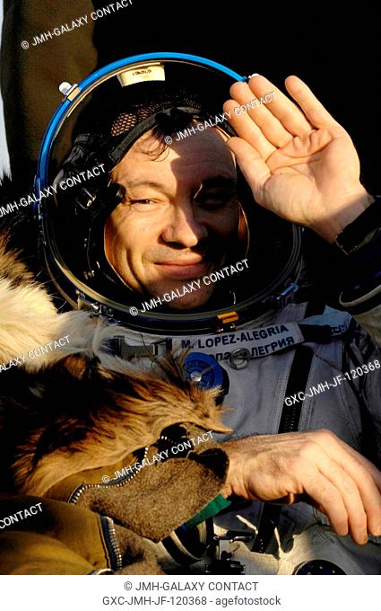 Astronaut Michael E. Lopez-Alegria, Expedition 14 commander and NASA ISS science officer, uses his hand to shade his eyes while seated in a chair in front of...