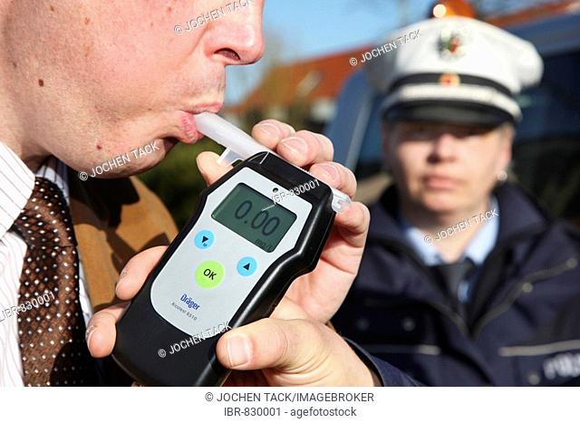 Alcohol breath test, driver being tested with a breathalyzer, breathalyser, Mettmann, North Rhine-Westphalia, Germany, Europe