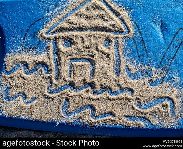 A house drawn by a child in the sand