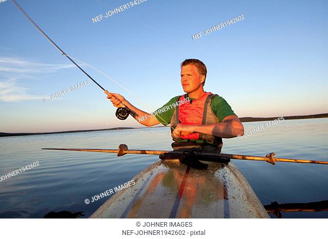 Young man fishing, Sweden