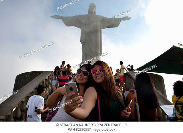 Two girls from Peru take a selfie in front of the Christ the Redeemer statue in Rio de Janiero, Brazil, July 30, 2016. The Rio 2016 Olympic Games take place...