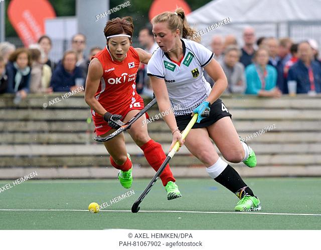 Korea's Kim Bomi (L) and Germany's Nike Lorenz vie for the ball during the women's Nations Tournament hockey match between South Korea and Germany at the...