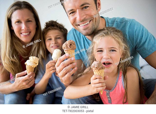 Family with two children (6-7, 8-9) holding ice cream cones