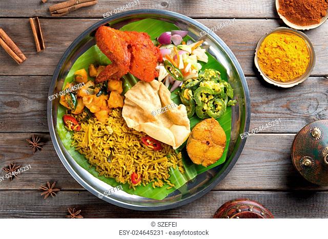 Overhead view of full length Indian biryani rice on wooden dining table background