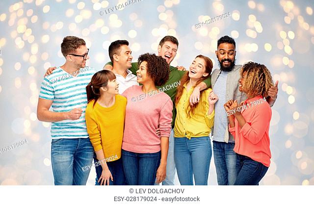 diversity, race, ethnicity and people concept - international group of happy men and women laughing over holidays lights background