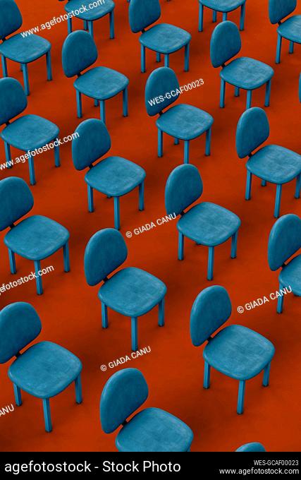 Rows of blue empty chairs on red background