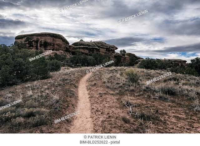 Clouds over desert path, Moab, Utah, United States
