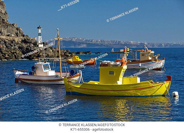 Colorful fishing boats in Ammoudi Bay near Oia Thira, on the Greek Island of Santorini, Greece