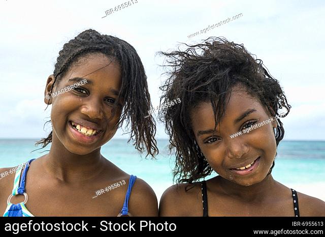 Pretty young local girls, on the world class Shoal Bay East beach, Anguilla, Caribbean, British Oversea territory, United Kingdom, Europe