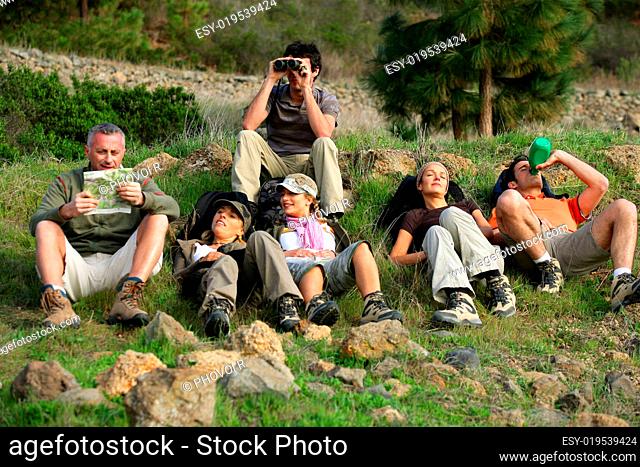 men and women lying on a hike in the grass