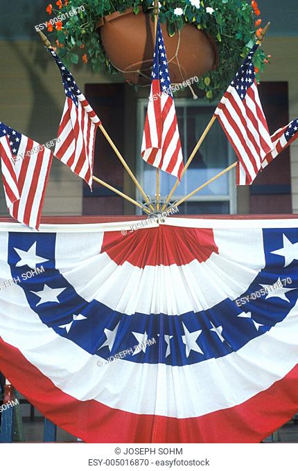 American Flags and bunting Hung on Porch of House