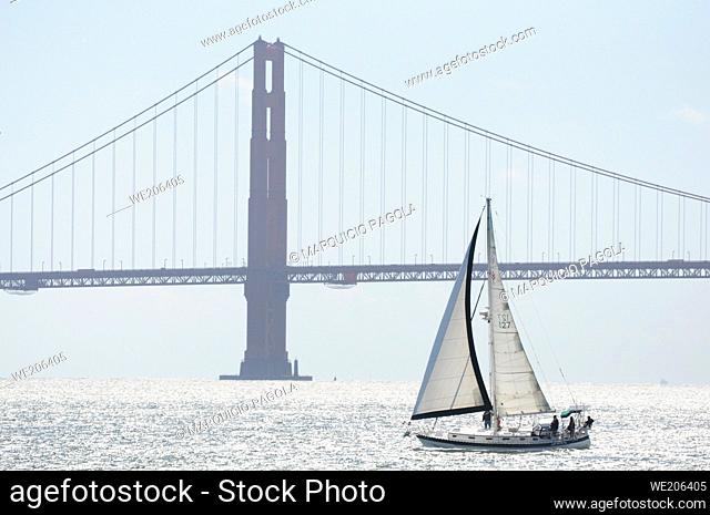 Sailboat crossing the San Francisco Bay, with the Golden Gate Bridge in the background