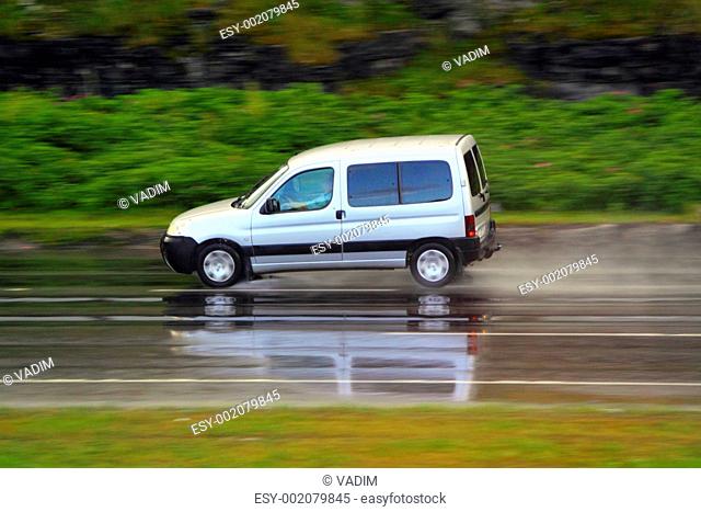 car on wet road on high speed
