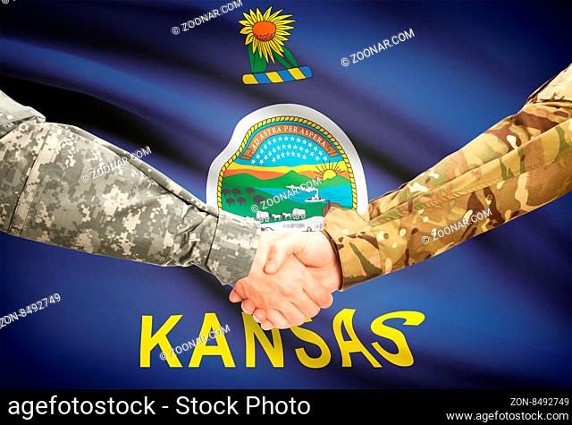 Soldiers handshake and US state flag - Kansas