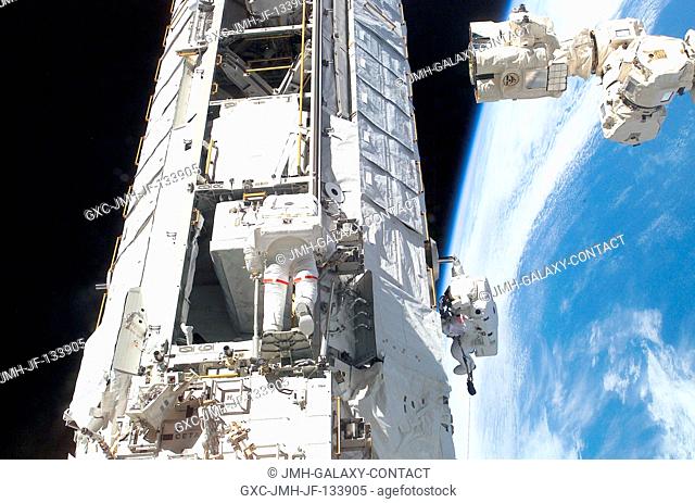Astronauts Michael E. Lopez-Alegria (left) and John B. Herrington, STS-113 mission specialists, work on the newly installed Port One (P1) truss on the...