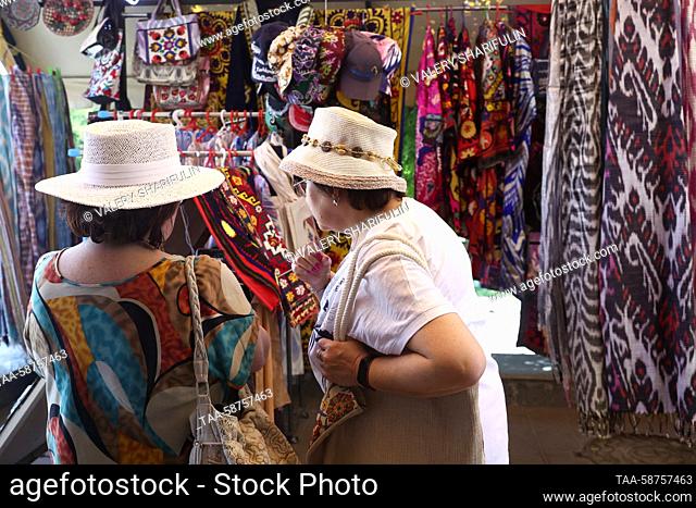 UZBEKISTAN, TASHKENT - APRIL 30, 2023: Women shop for shawls at Oloy Bazaar. Valery Sharifulin/TASS