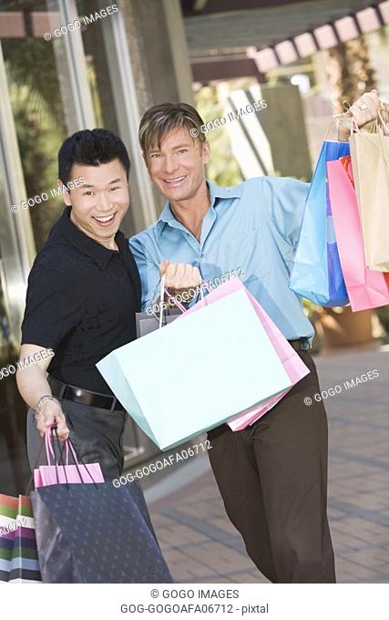 Gay couple carrying shopping bags