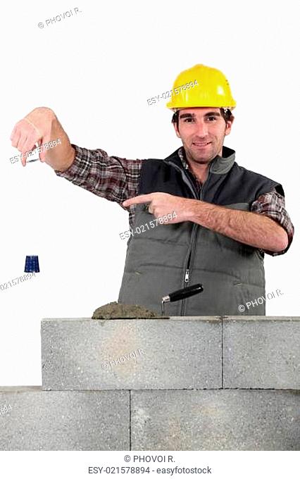 Bricklayer checking that wall is level