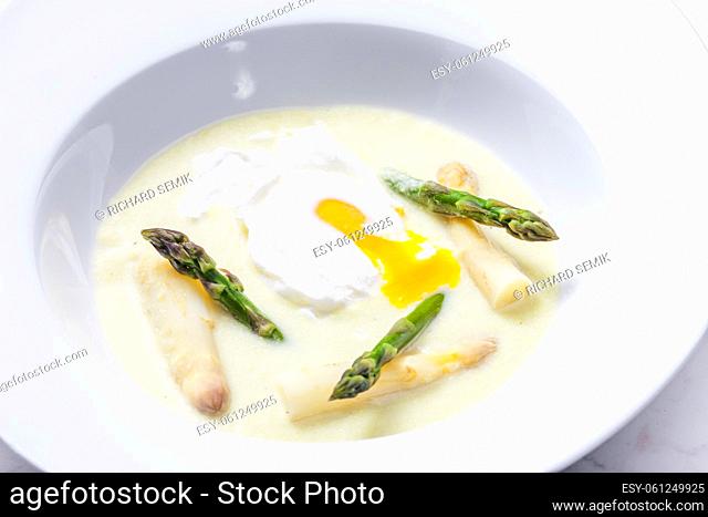 white and green asparagus soup with poached egg