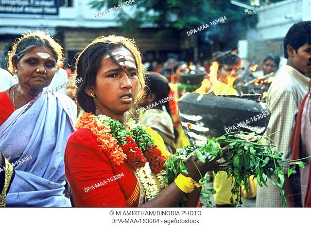 Devotee holding firepot in Mariamman Festival ; Coimbatore ; Tamil Nadu ; India NO MR
