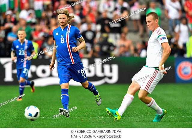 Birkir Bjarnason (C) of Iceland and Adam Lang (R) of Hungary challenge for the ball during the Uefa Euro 2016 Group F soccer match between Iceland and Hungary...