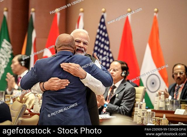 dpatop - 09 September 2023, India, Neu Delhi: Narendra Modi (r), Prime Minister of India, hugs Azali Assoumani of the African Union (AU) at the G20 Summit...
