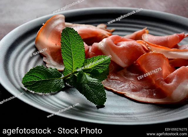 Italian or Spanish prosciutto crudo or jamon . Raw ham