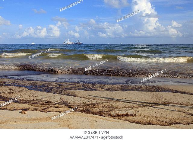 Waves washing oil ashore from the BP Deepwater Horizon oil leak. Baldwin County, Alabama. June 2010
