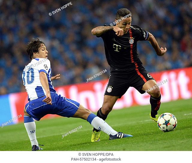Munich's Thiago Alcantara (R) vies for the ball with Porto's Oliver Torres during the UEFA Champions League quarter final first leg soccer match between...