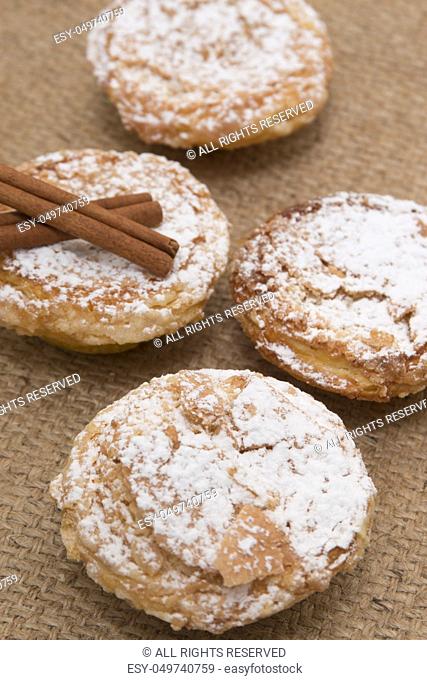 Famous Portuguese flaky Bean pastry sprinkled with white sugar powder on hessian fabric