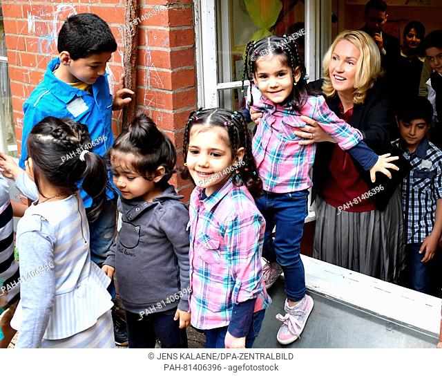 German Minister of Family Affairs Manuela Schwesig visits the German Red Cross (DRK) emergency accommodation for refugees and leaves the playroom through the...