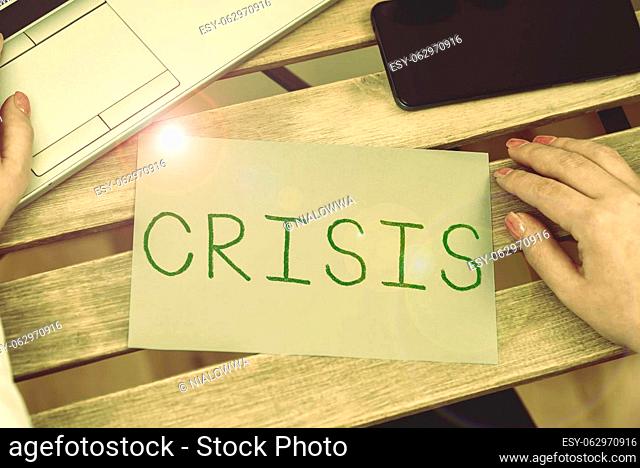 Writing displaying text Crisis, Business overview event that is going to lead to an unstable and dangerous situation