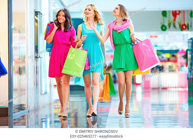 Beautiful girls in smart dresses walking in the mall