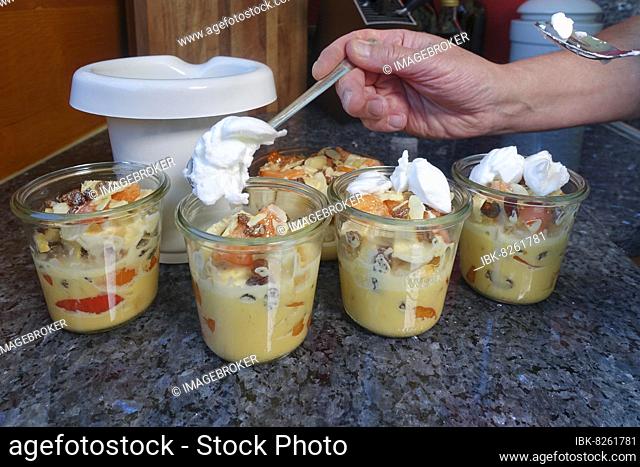 Swabian cuisine, preparation of sweet Ofenschlupfer with apricots, mixture of apricot pieces, rolls from the previous day, sultanas