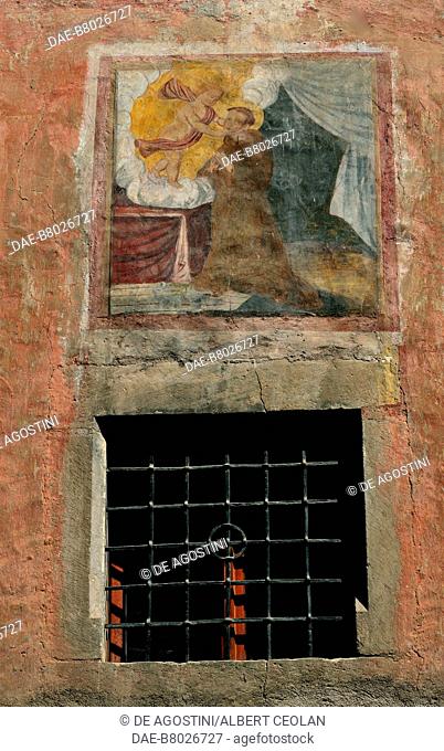 Exterior wall of a stone house decorated with religious scene, Pressano, Piana Rotaliana, Trentino-Alto Adige, Italy