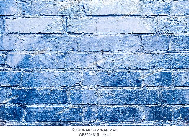 brick wall with blue, silver colored paint