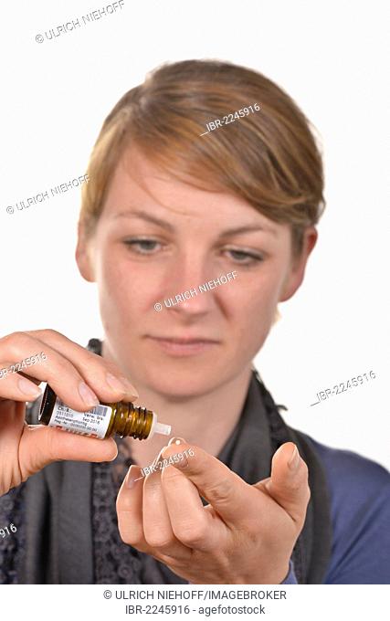 Woman taking homeopathic globules