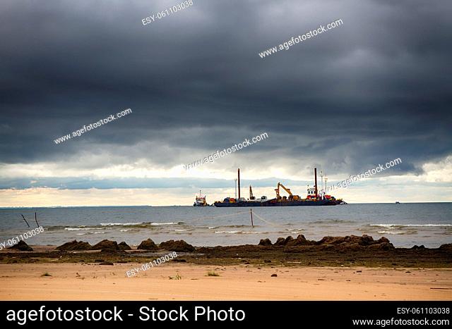 Construction of offshore section of gas pipeline on bottom of Baltic sea Nord stream-2. Pier goes into Nara Bay, excavator aligns bottom under bed of gas...