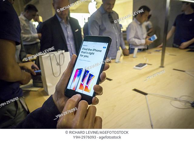 Customers in the Apple store in Grand Central Terminal in New York try out the new iPhone 8 Plus on Friday, September 22, 2017, the first day it went on sale