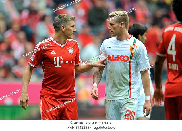 Bayern's Bastian Schweinsteiger (L) talks to Augsburg's Andre Hahn during the Bundesliga soccer match between Bayern Munich and FC Augsburg at Allianz Arena in...