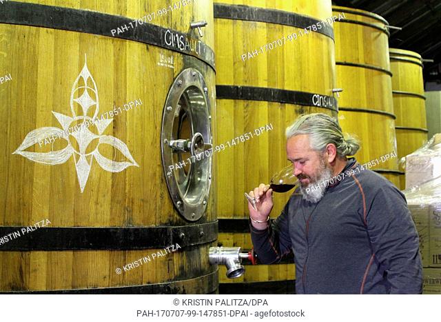 Winemaker Adi Badenhorst fetches a glass of Grenache from this year's harvest at his vinyard between Wellington and Paarl, South Africa, 20 July 2017